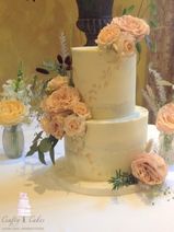 Semi naked gold leaf buttercream wedding cake